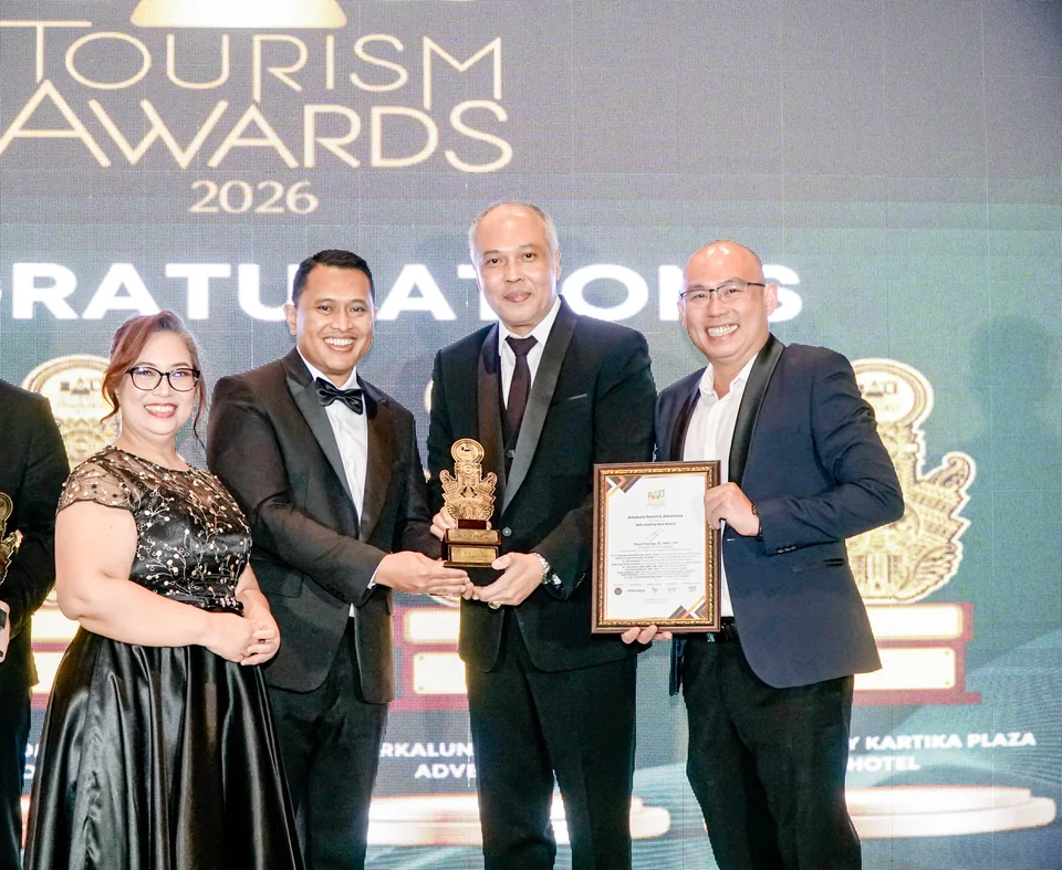 A group on stage with Arkaluna's trophy and certificate at the 11th Bali Tourism Awards 2026